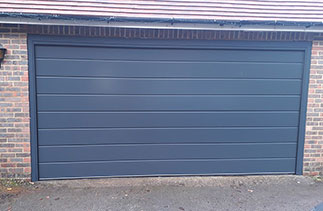 A Carteck 40mm insulated Centre Rib style sectional garage door, in Anthracite Grey. Fitted in Farnham, Surrey