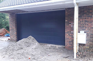 A Carteck 40mm insulated sectional garage door in the Centre rib style. In Anthracite Grey. Fitted in Tilehurst, Reading, Berkshire.