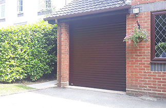 A Sws Seceuroglide Excel Insulated Roller Shutter Garage Door in Rosewood. Fitted in Westend, Surrey.
