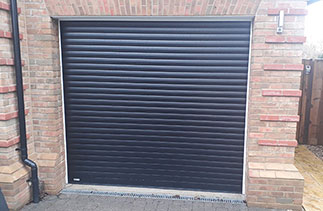 A Sws Seceuroglide Insulated Roller Shutter Garage Door in Black. Fitted in Warfield, Berkshire