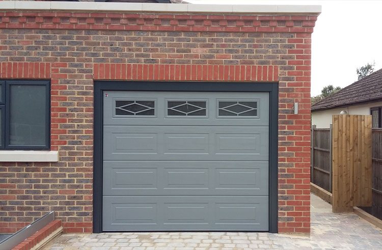 Carteck sectional Garage door in RAL 7037 with a RAL 7016 frame and 3D cover profile kit, with Rhombus widows