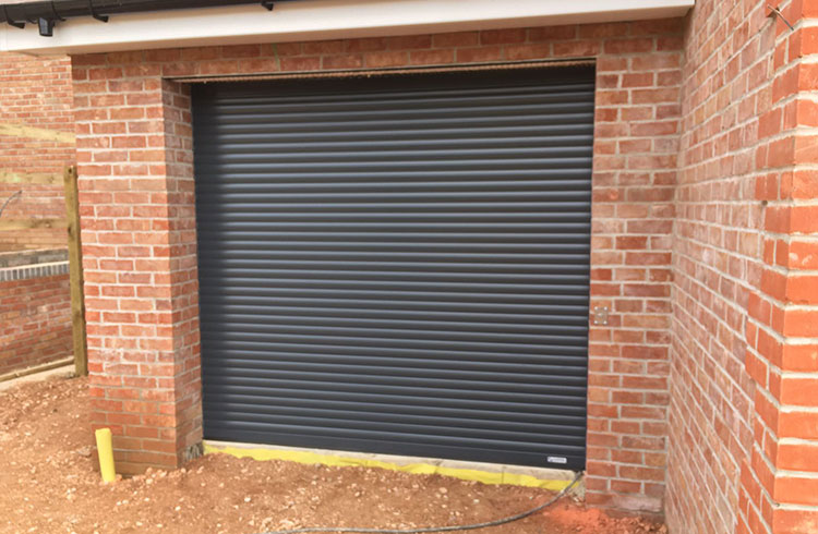 A Gliderol compact insulated electronically operated roller shutter garage door in Anthracite Fitted in Four Marks