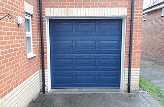 A Carteck 40mm insulated sectional garage door in a Georgian style in Navy blue (ral 5011) fitted in Lightwater, Surrey.
