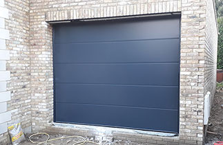 A Carteck sectional garage door in the Solid Rib style. Finished in Anthracite smooth finish. Door fitted in Esher, Surrey.