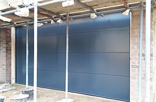 A Carteck Solid Rib sectional garage door in Anthracite Grey on a smooth finish. Fitted in Camberley, Surrey.