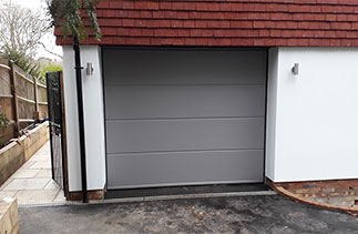 A Carteck solid rib sectional garage door in a Ral colour. Fitted in Guildford, Surrey.