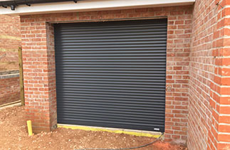 A Gliderol compact insulated electronically operated roller shutter garage door in Anthracite Fitted in Four Marks