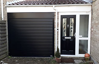 A Gliderol 77mm Black insulated roller shutter garage door fitted with a matching full box and within the opening. Garage door fitted in Camberley, Surrey.