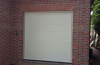 One of Three Hormann S – ribbed sectional garage doors in Ral 9001. Fitted behind the structural opening complete with a external wireless key pad. Fitted in Beaconsfield, Buckinghamshire