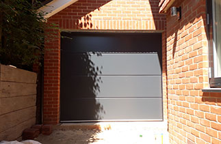 One of Two Carteck Solid rib sectional garage doors in Anthracite Grey. Fitted in Guildford, Surrey