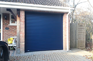 A Sws Seceuroglide Excel roller shutter garage door in Navy Blue fitted in Basingstoke, Hampshire.