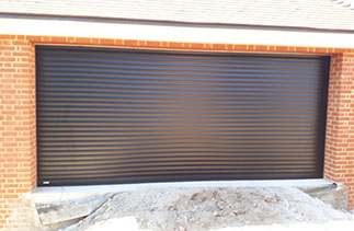 A Sws Seceuroglide Excel roller shutter garage door in Black. Fitted in Bramley, Surrey.