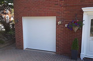 A Sws Seceuroglide Excel roller shutter garage door in white. Fitted in Camberley, Surrey.