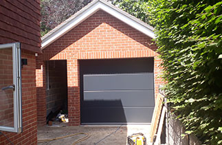 Two of Two Carteck solid rib sectional garage doors in Anthracite Grey. Fitted in Guildford. Surrey.