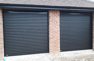 Two Sws Seceuroglide Excel Black Wood grain insulated Roller Shutter Garage Doors fitted in Guildford, Surrey