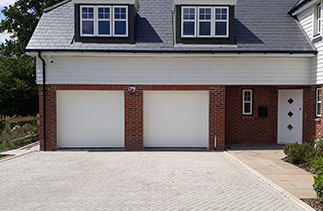 Two Sws Seceuroglide Excel roller shutter garage doors in White Woodgrain. Fitted in Fleet, Hampshire.