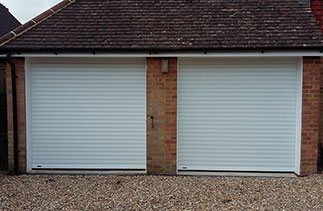 Two White Seceuroglide Excel roller shutter garage doors fitted with white upvc fascia’s and white upvc on the brick faces. Fitted in Westend, Surrey.