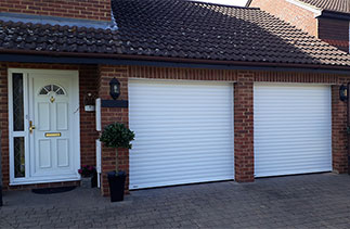 Two White Seceuroglide Excel insulated Roller Shutter garage doors fitted in Egham, Surrey.