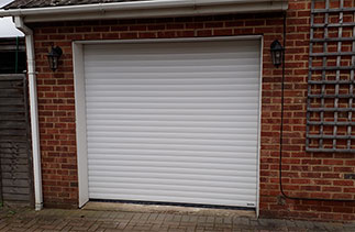 A White Gliderol 77 insulated, electronically operated Roller Shutter Garage Door fitted in Ashvale, Hampshire.